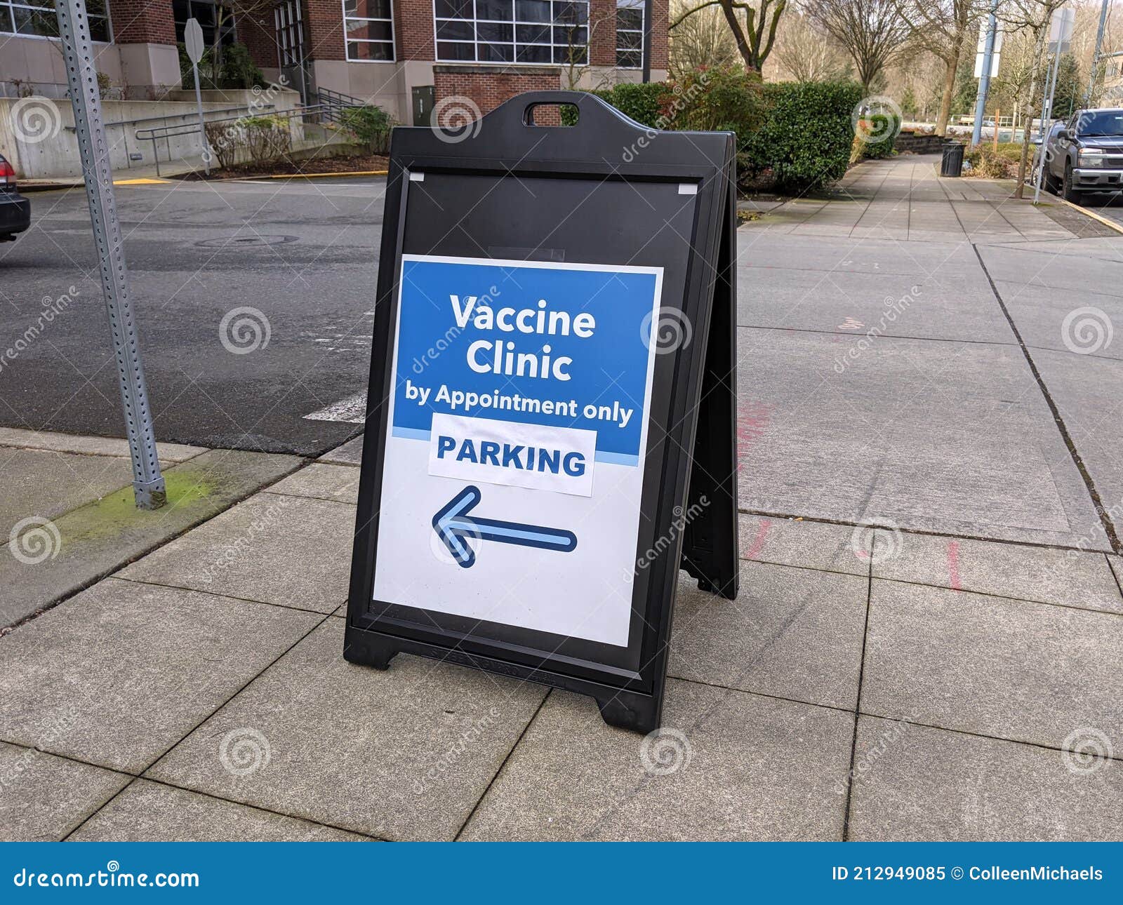 street view of a sign pointing out the way to a vaccine clinic