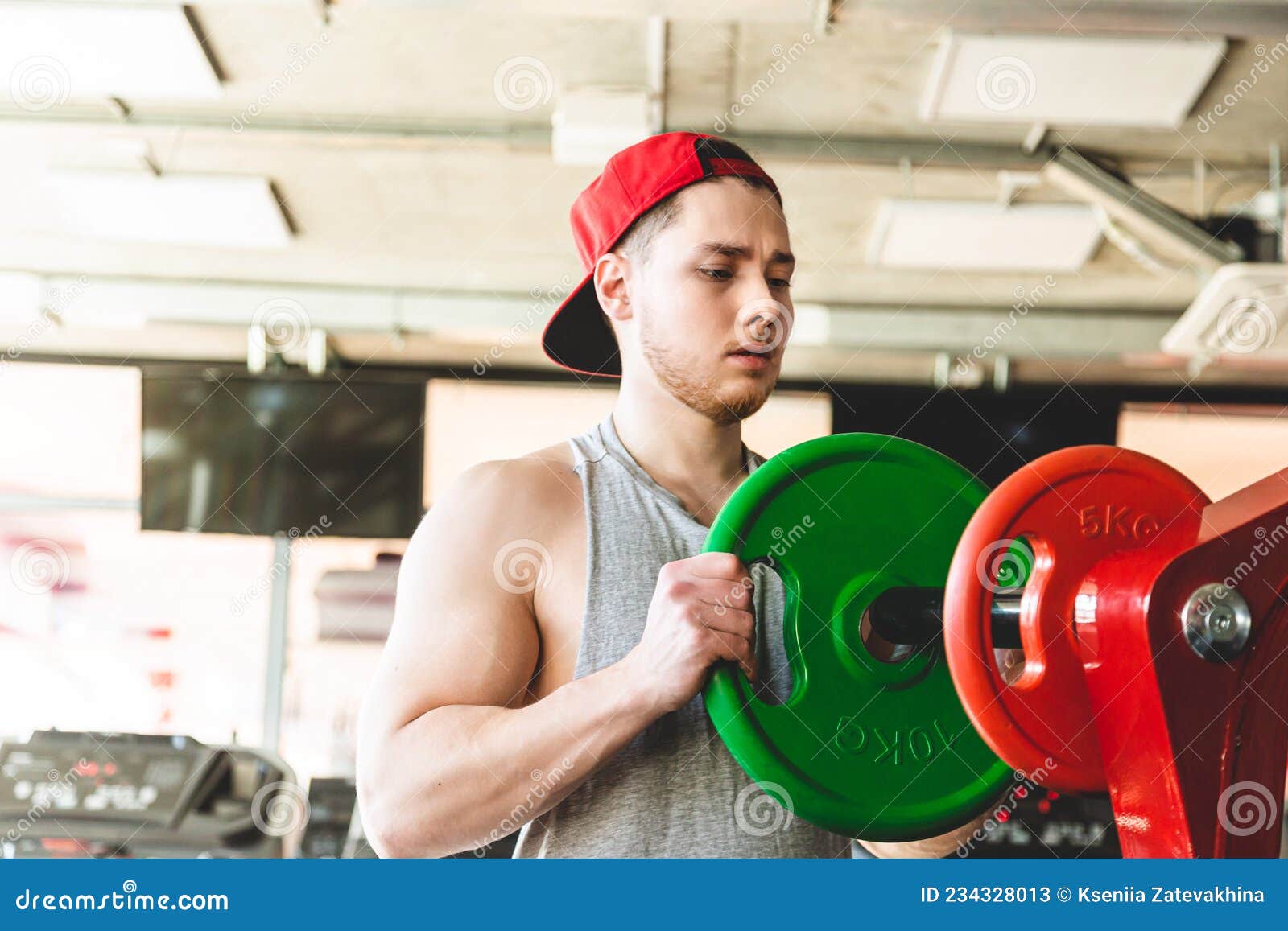 Strength Training of a Muscular Young Athlete in the Gym. Stamina and
