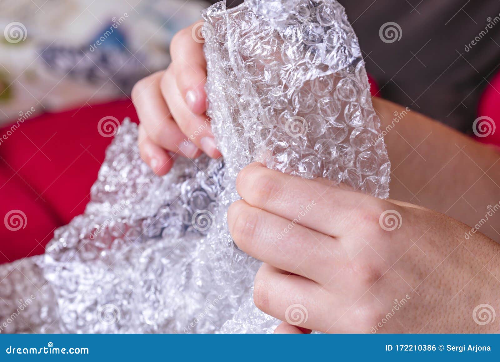 stress concept. woman`s hands popping bubbles from a bubble paper