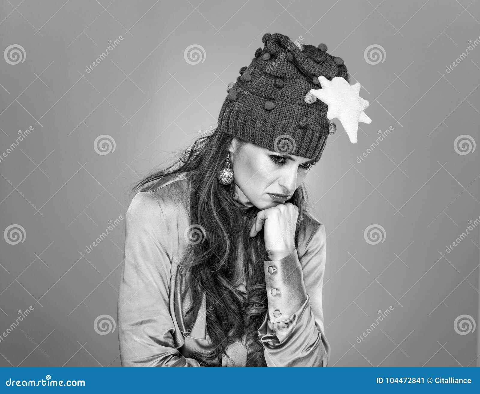 Stress season stressed elegant woman in funny Christmas hat isolated on grey thinking