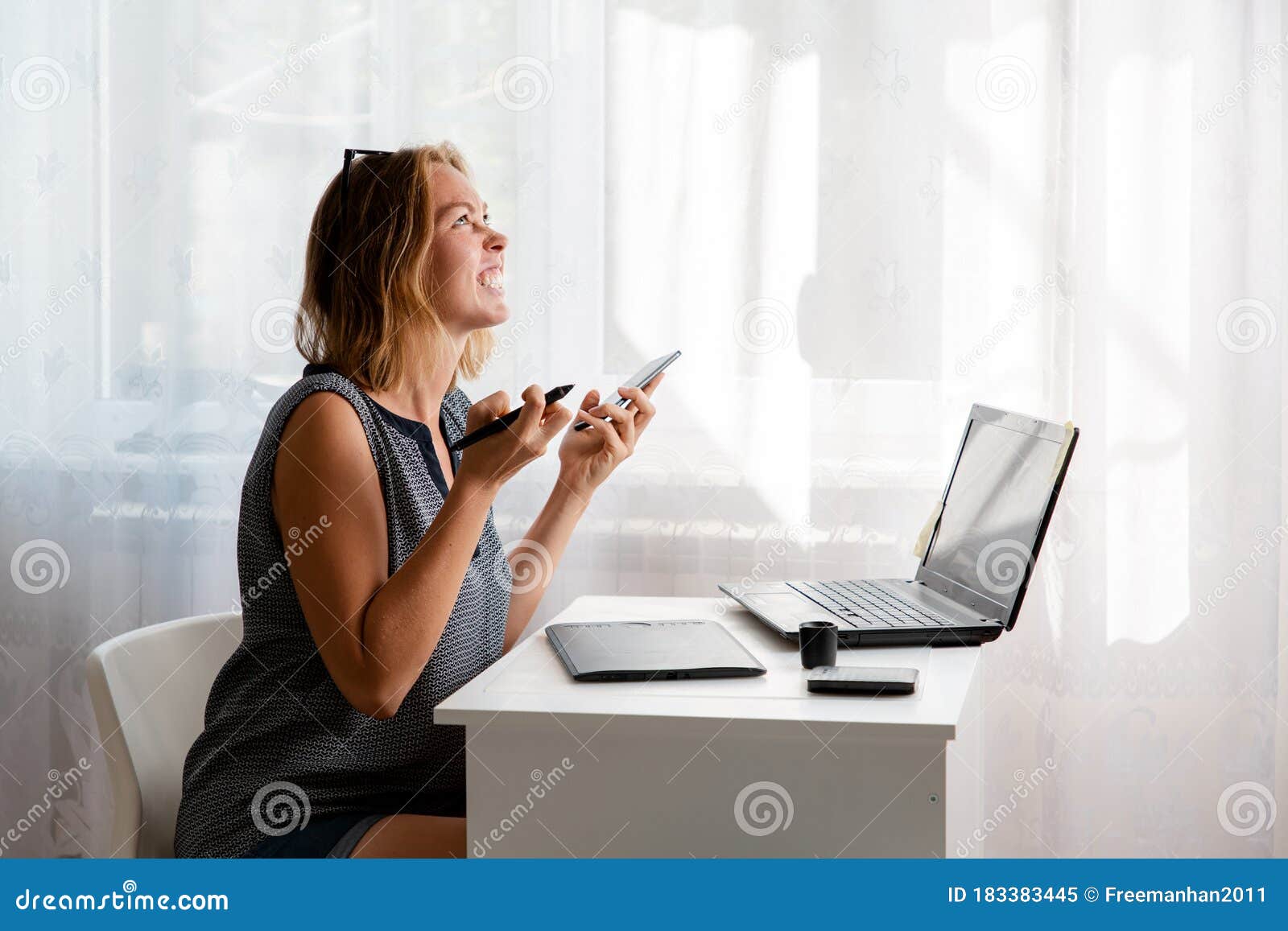 Stress At Work A Young Caucasian Woman Screams In Exasperation Holding A Phone In Her Hands There Is A Light Window In The Stock Image Image Of Digital Editor