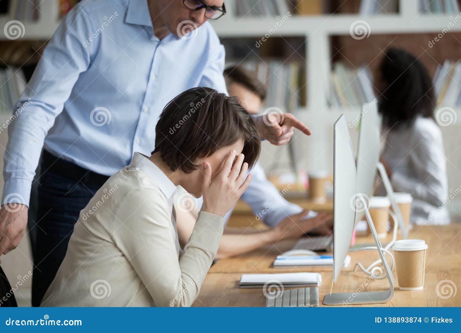 stressed female employee suffering from discrimination of angry male boss