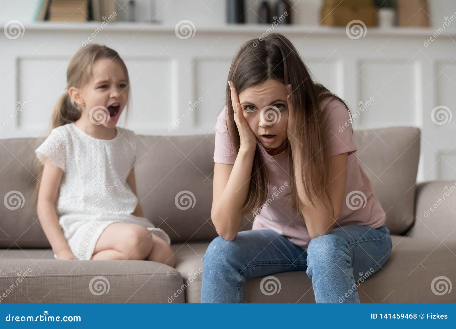 stressed mother feeling desperate about screaming stubborn kid daughter tantrum
