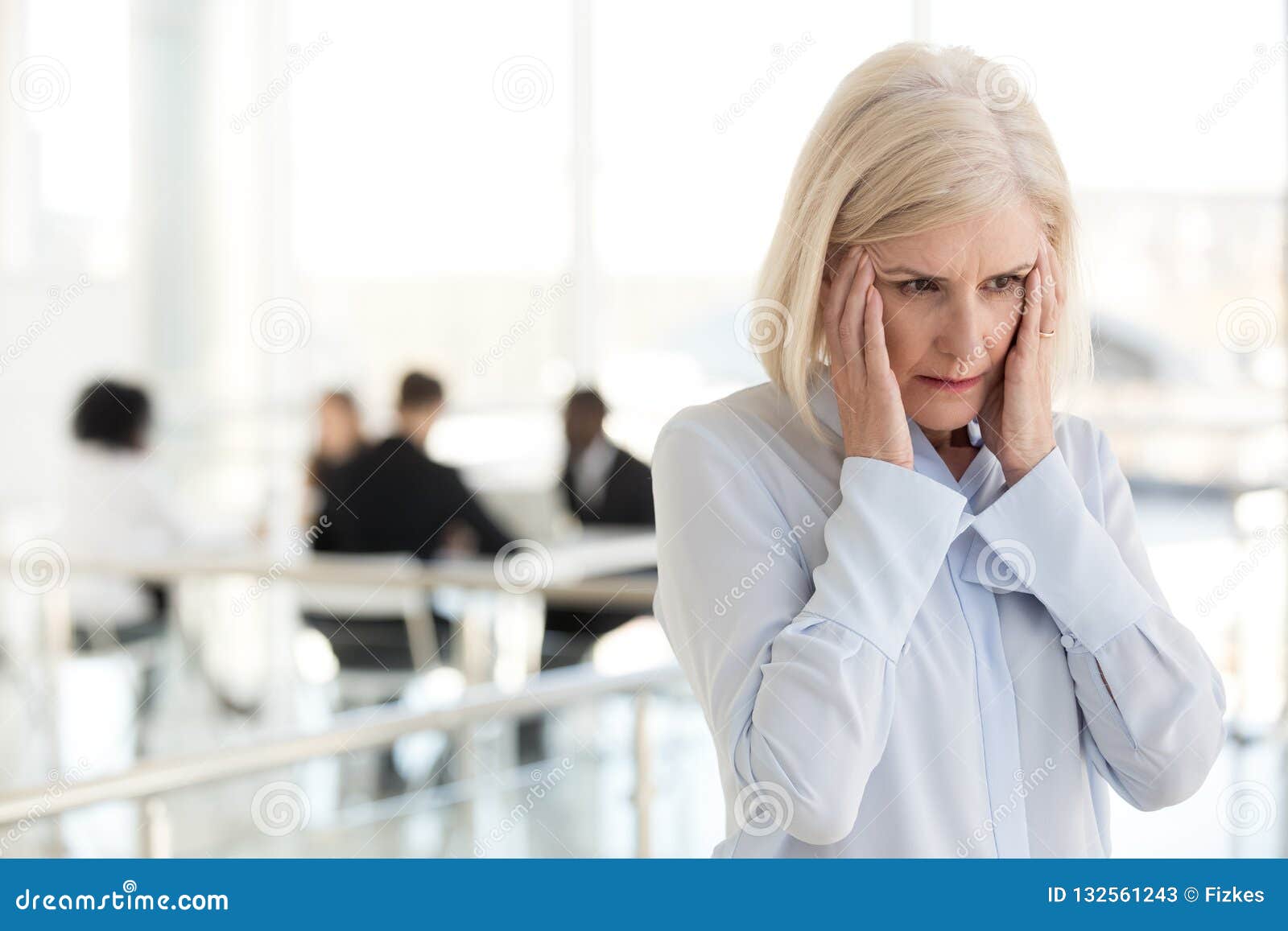 stressed fatigued mature businesswoman suffer from headache in o