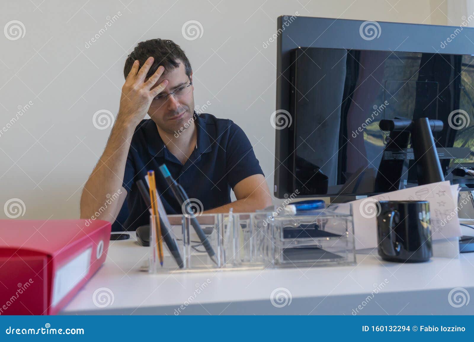 stressed man at job into office in front of his computer.office clerk into burn out concept