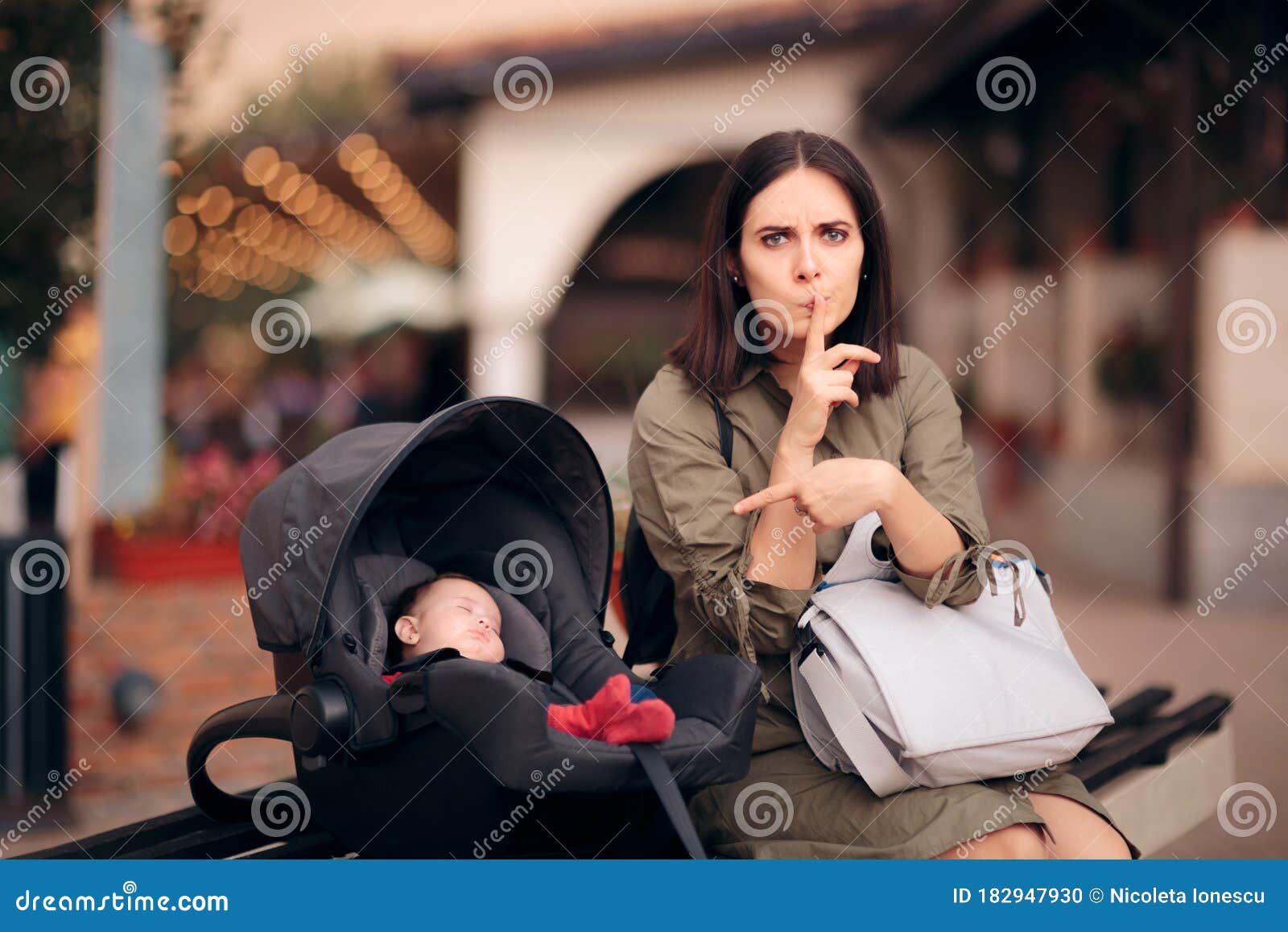 Stressed Mom With Finger On Lips Protecting Sleeping Baby S