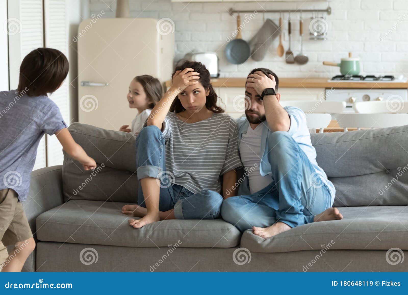 stressed young parents tired of crazy loud children.