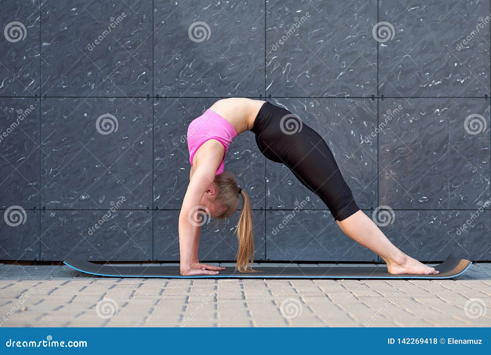 Stretching Woman Doing Exercise Bridge Fitness Or Gymnast Or Dancer Training On Gray Wall