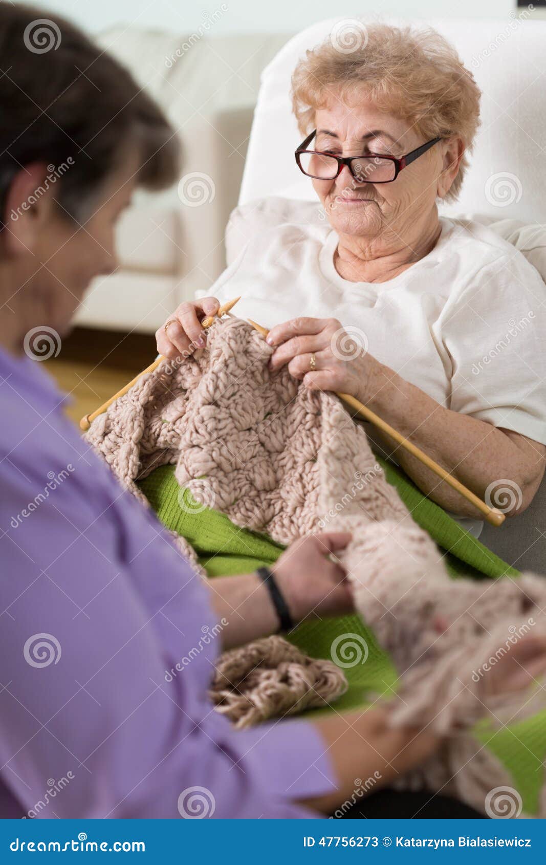 Stricken im Krankenhausbett. Kranke ältere Frauen, die im Krankenhausbett stricken