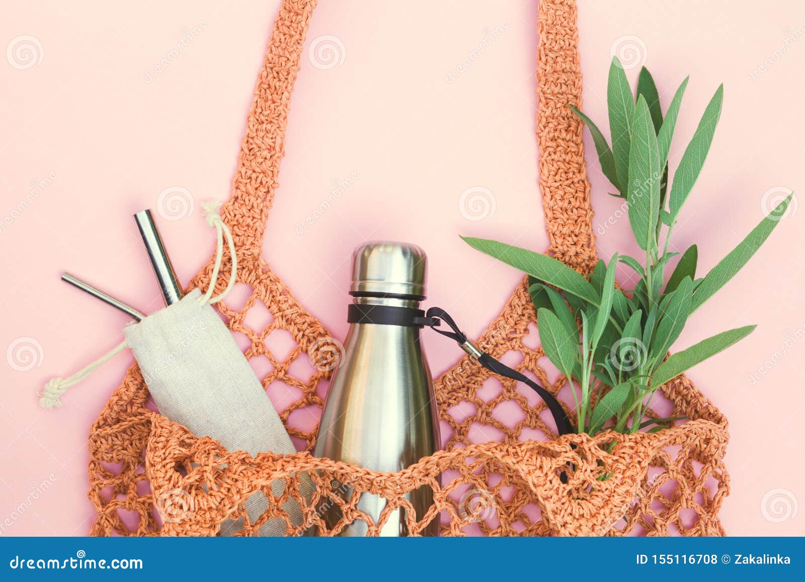 string bag with reusable water bottle and metal straws, go green and use no single use plastic