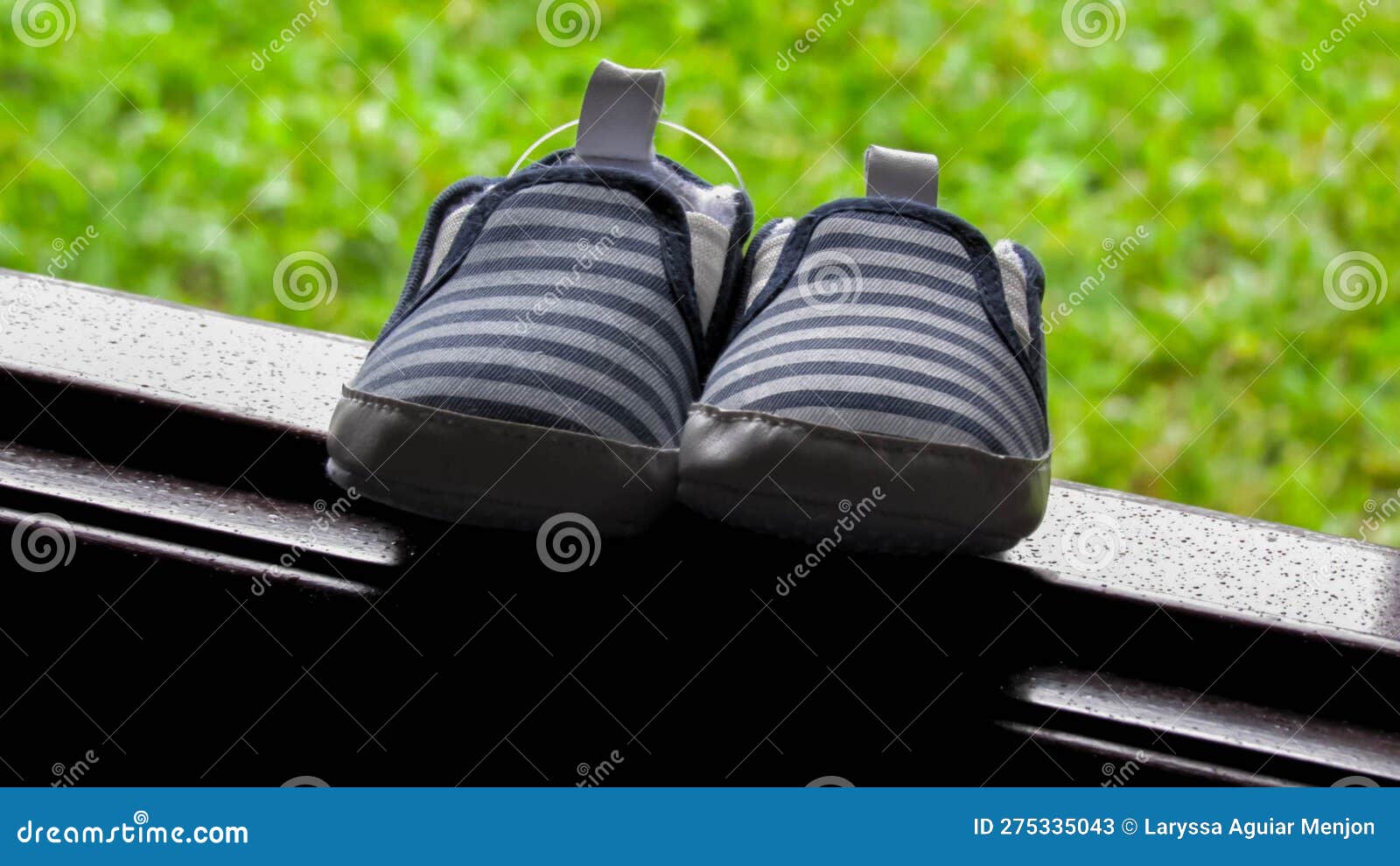 striped baby boy shoe with blue and white on window sill