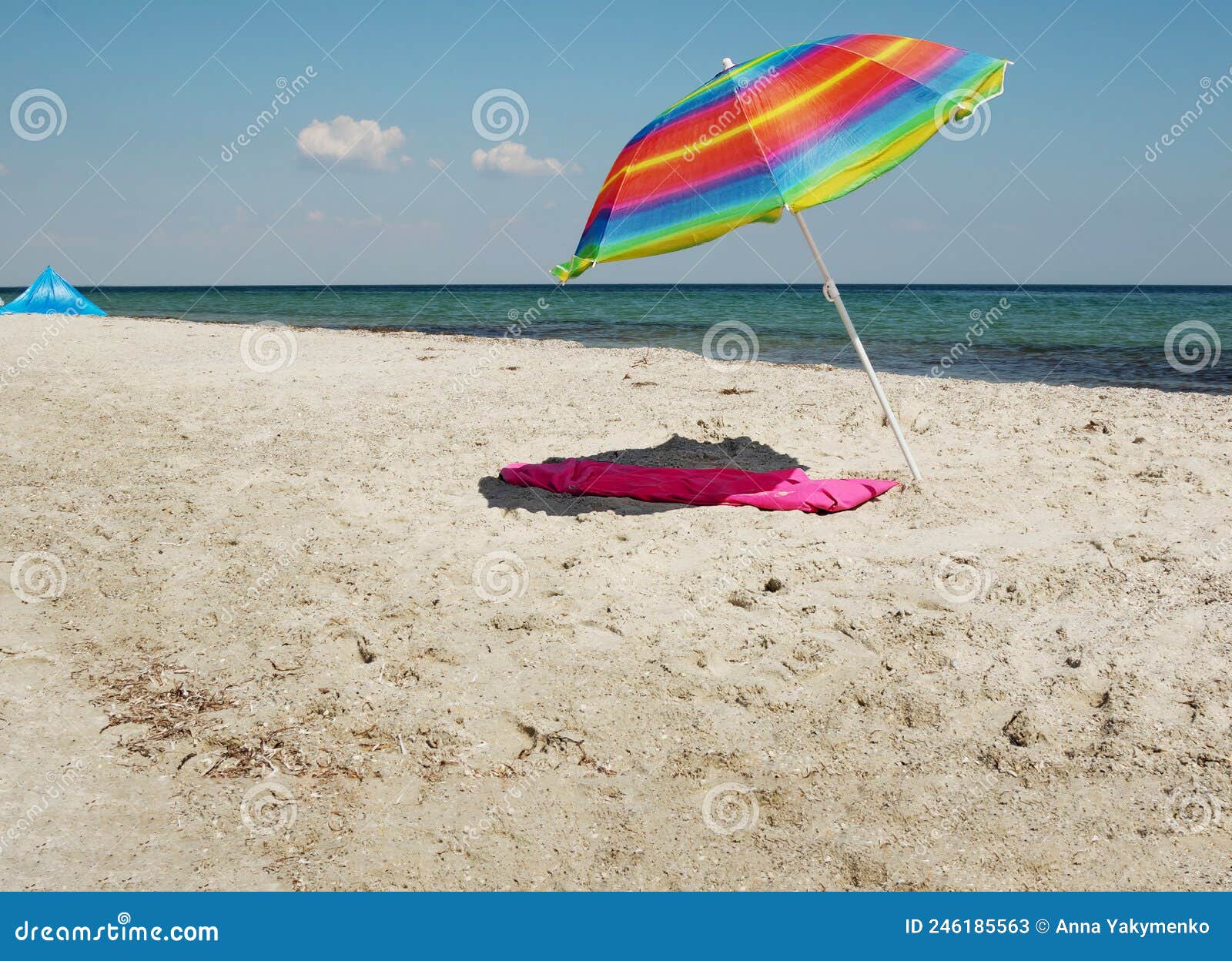 Striped Colored Beach Umbrella on Sand without People. Umbrella