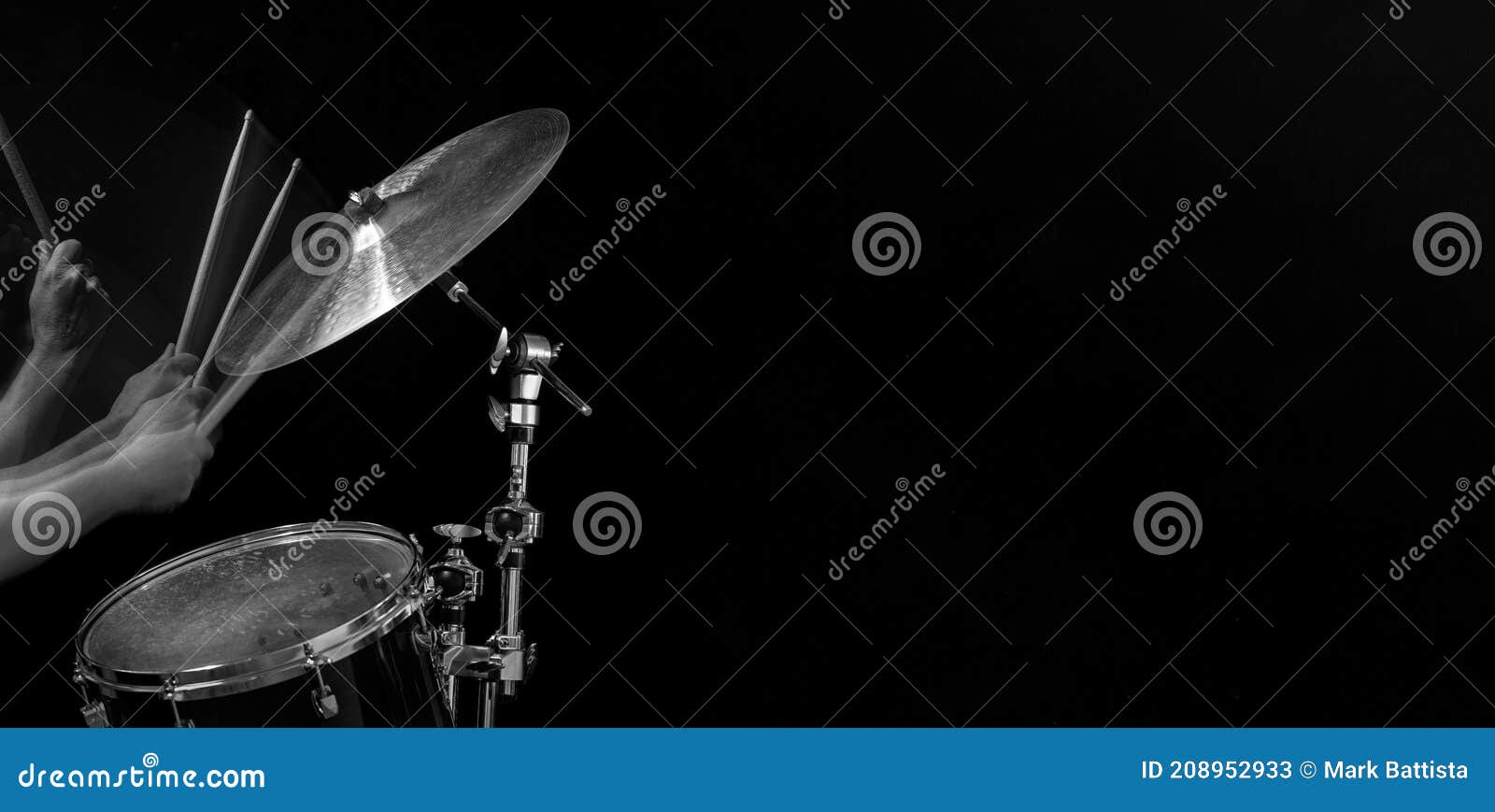 A Panoramic Image of a Drummer Hitting a Cymbal with Drumsticks Stock