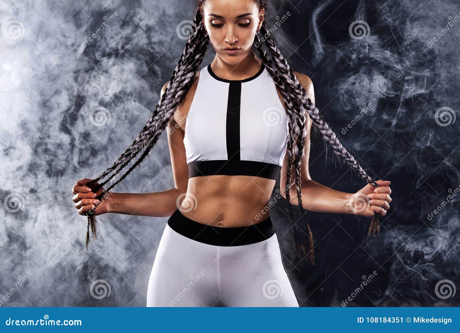 A Strong Athletic Woman on Black Background Wearing in White