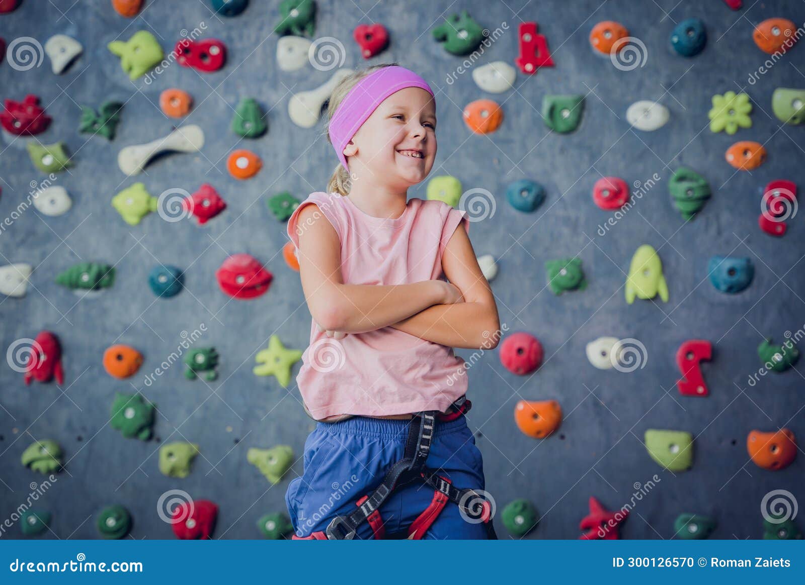 A Strong Baby Climber Posing for Photographer at Artificial Wall. Stock