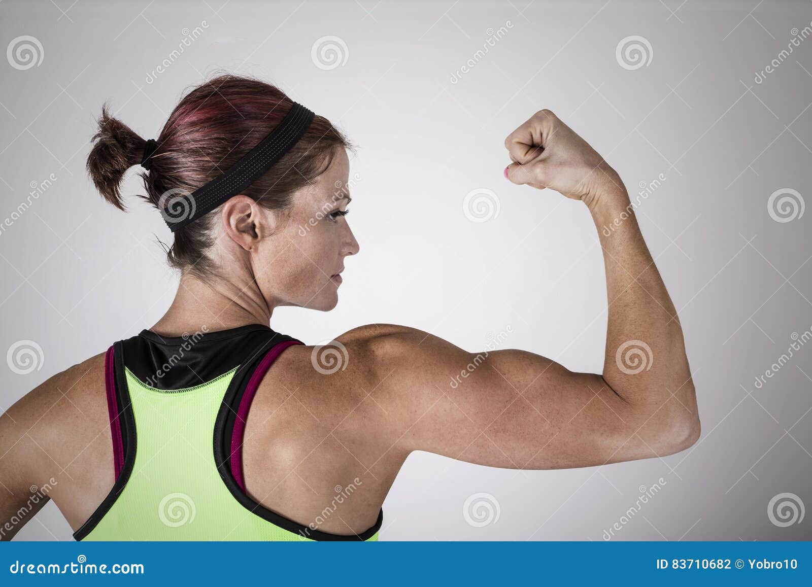 Confident Sporty Woman Flexing Muscles On Beach. Beautiful Young