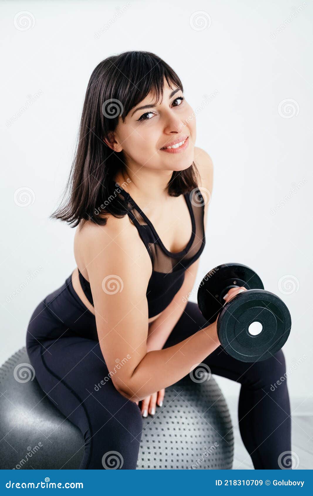 Happy woman, fitness and dumbbell exercise in gym for strong body