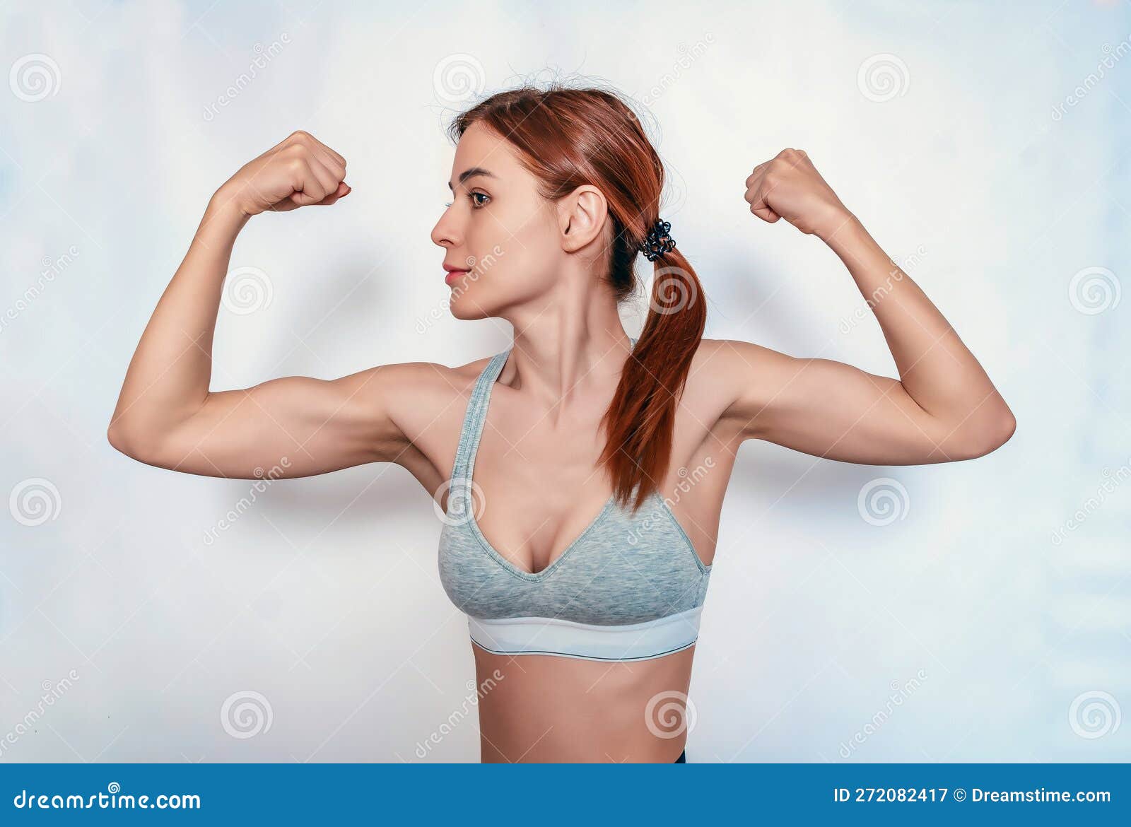 Young Woman Posing And Showing Biceps Stock Photo, Picture and Royalty Free  Image. Image 95690136.