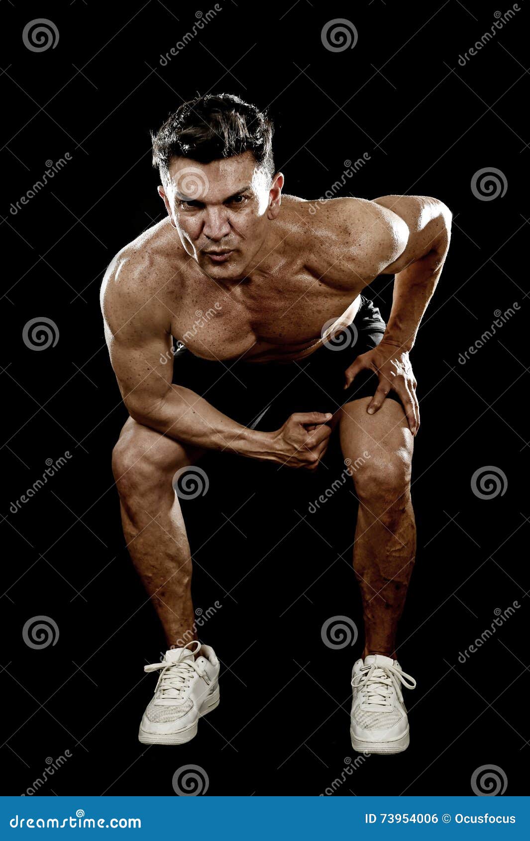 Strong Fit Man with Ripped Body Doing Squat Exercises Showing