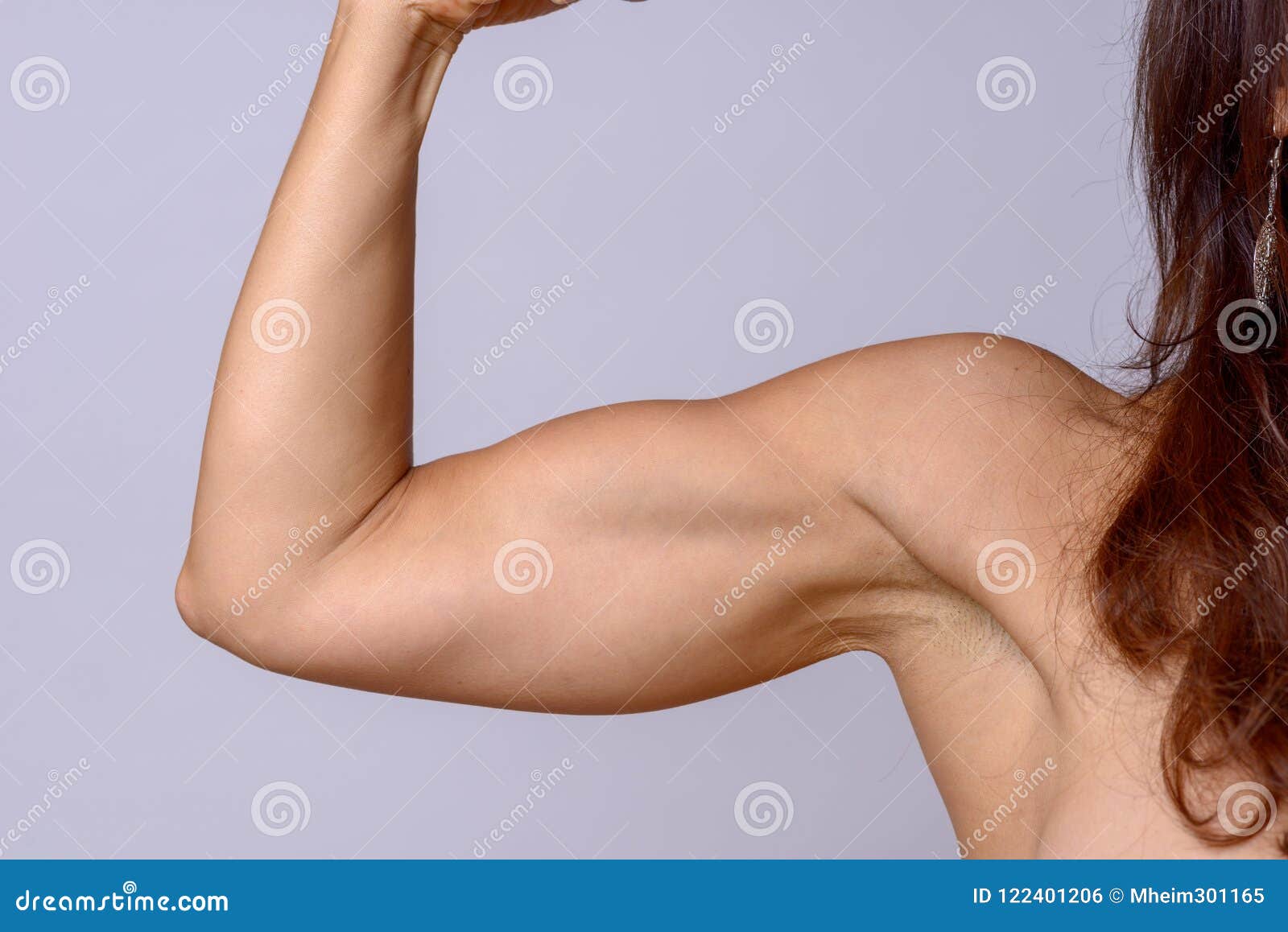 Fit Female Athlete Showcasing Toned Biceps In A Close-Up Shot