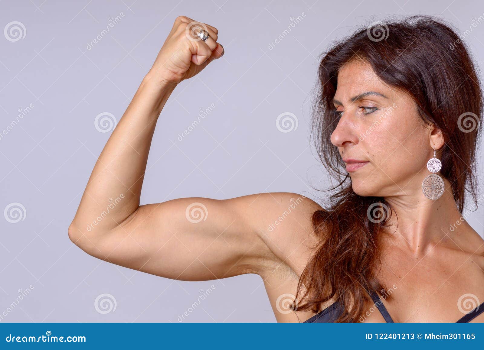 Strong Fit Mature Woman Flexing Her Arm Muscles Stock Image