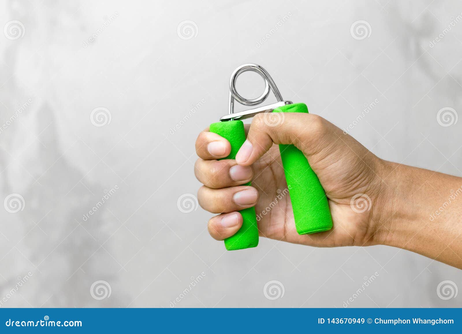 strong hand holding grip in gym background. grip strength for exercise.