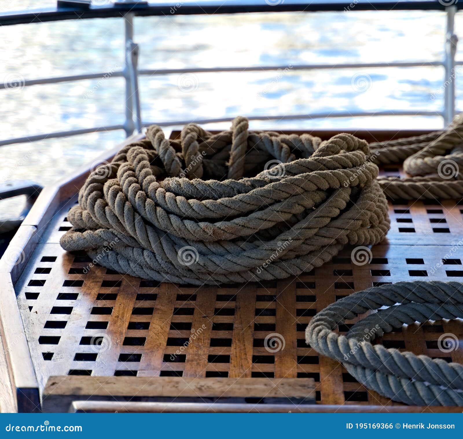 Marine Grade Rope on an Old Teak Deck of a Ship. Stock Photo