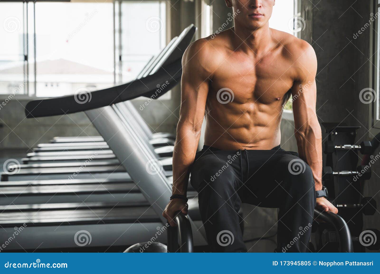 Muscular Man Working Out In Gym Doing Exercises With 