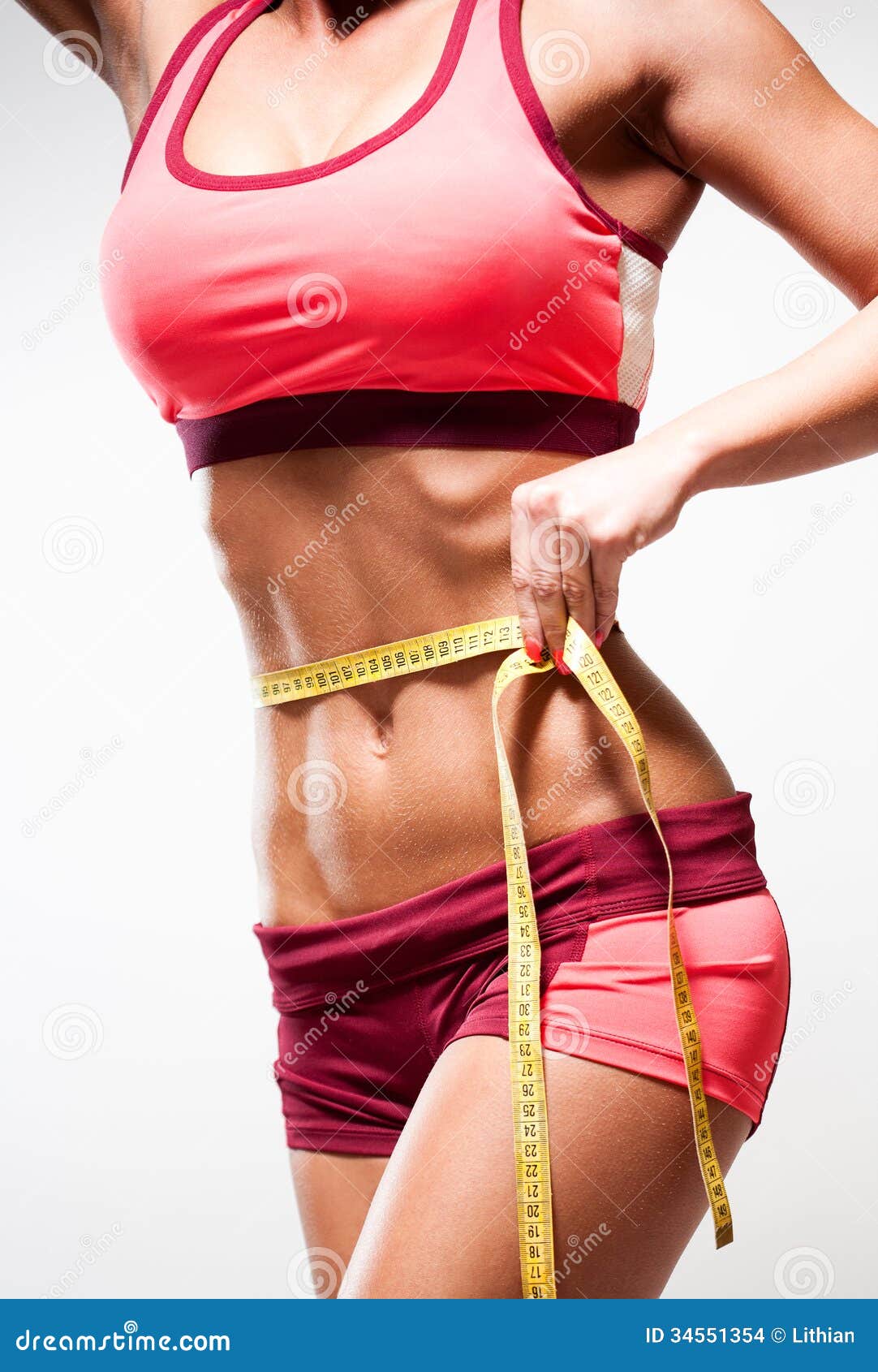 Obese man measuring waist with tape measure - SuperStock