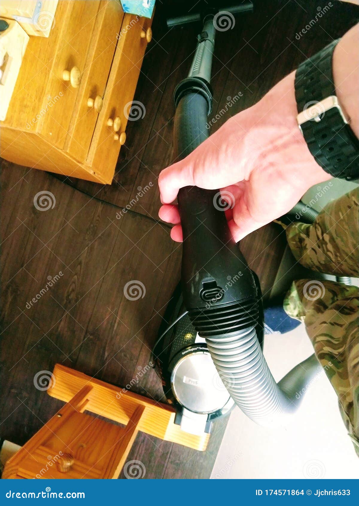 Struggling with the Vacuum Cleaner. Man Cleaning Badly and Stuck. Home