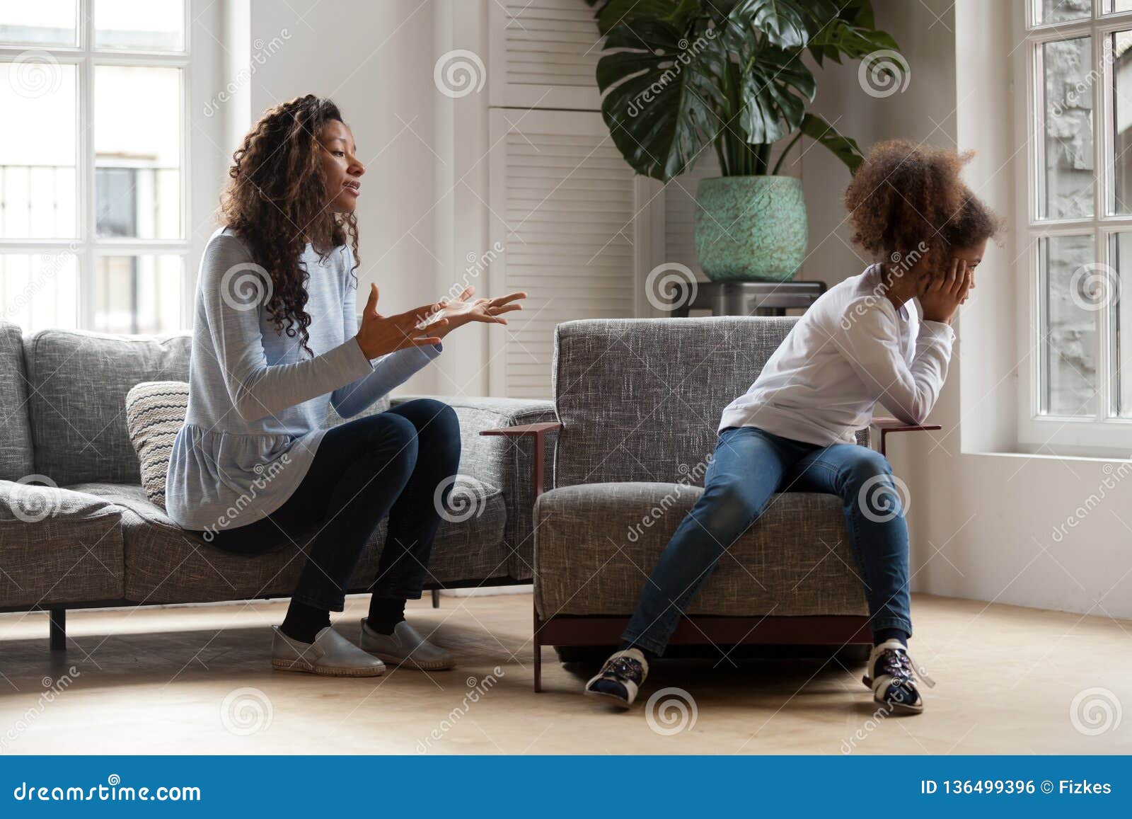 stubborn african kid ignoring mom scolding, parent and child con