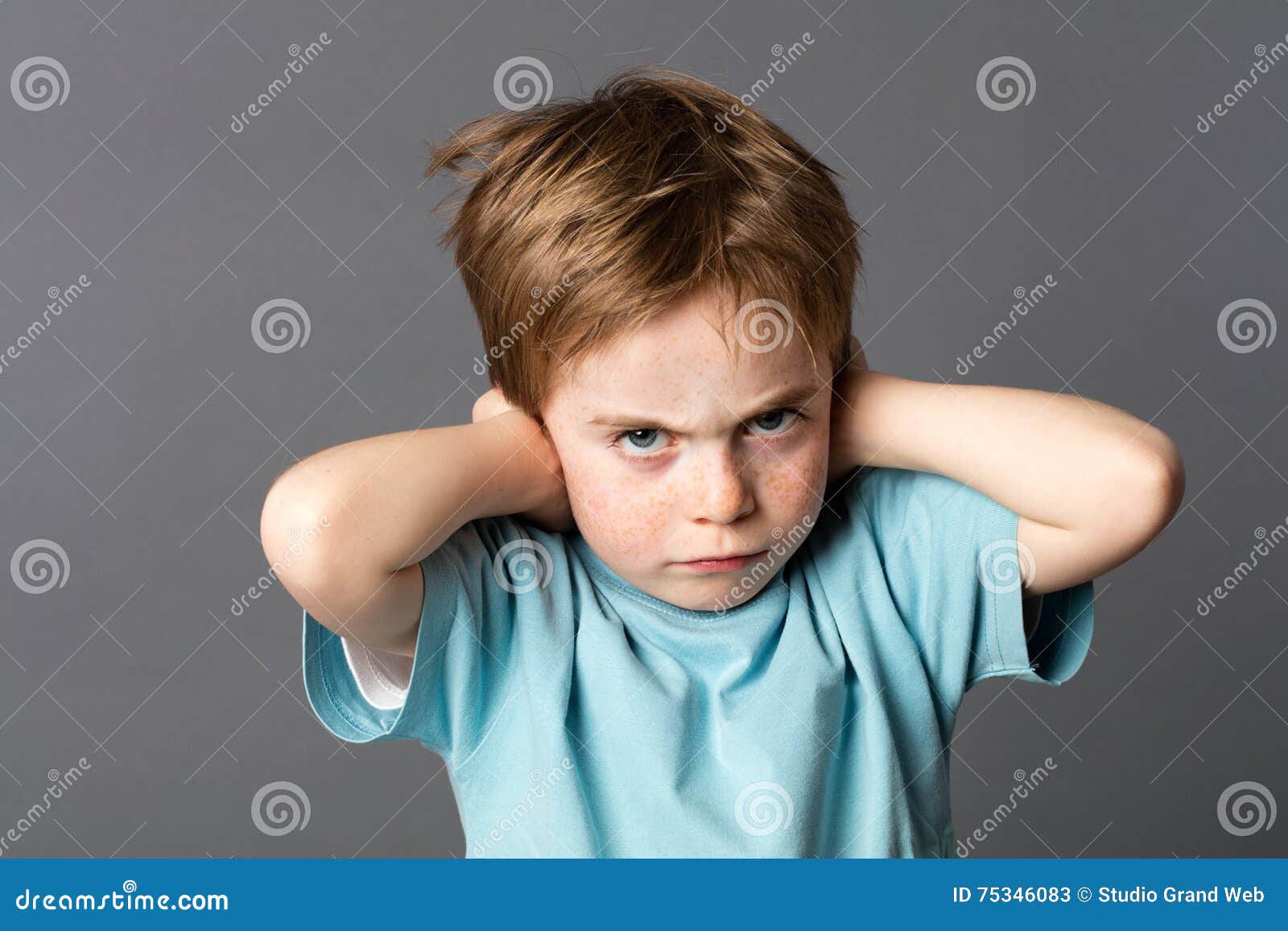 stubborn kid with an attitude ignoring parents scolding, blocking ears