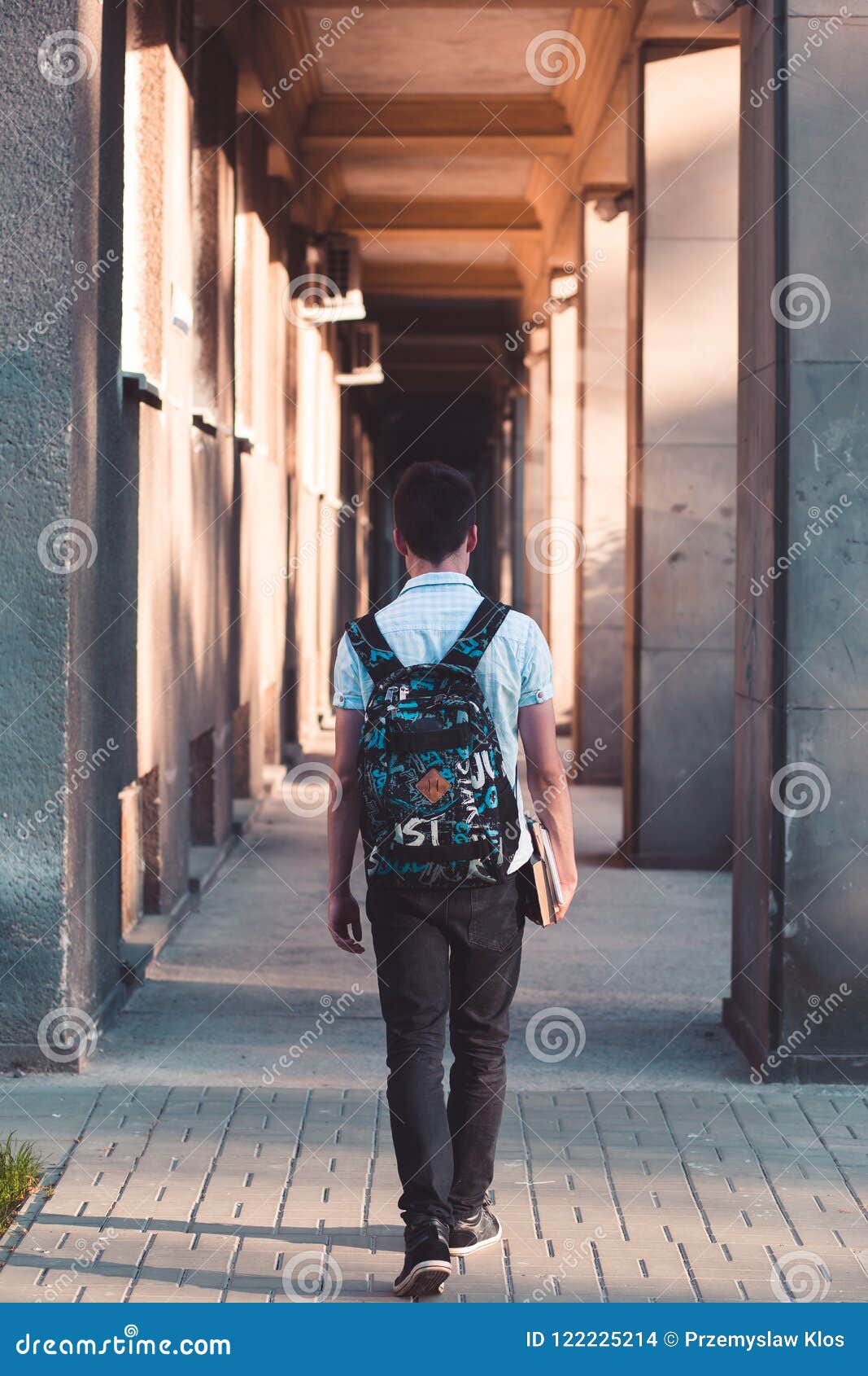 Student with the Books Walking at the Front of University Stock Photo ...