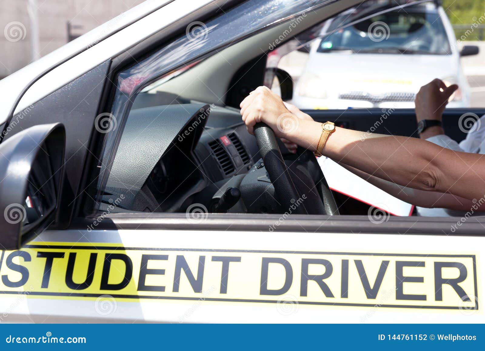 Student Driver Holding Steering Wheel during Driving Lesson Stock Photo