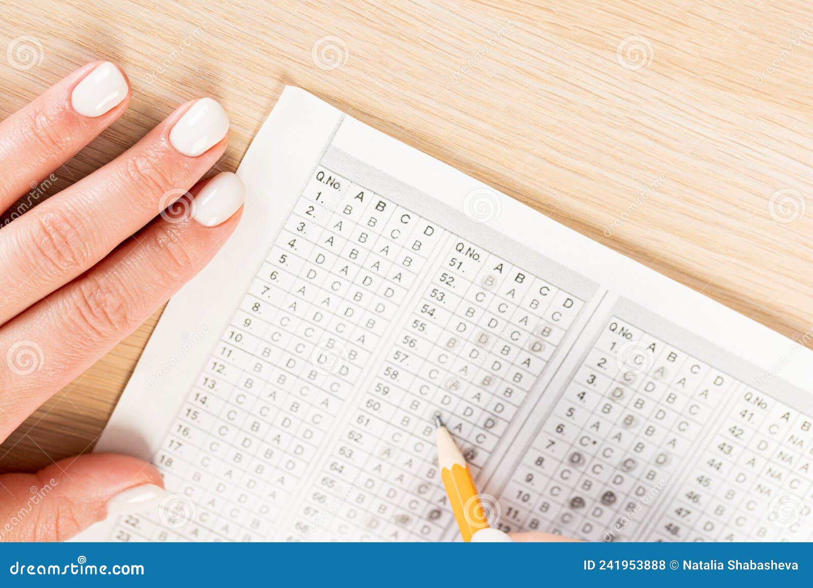 student hand testing in exercise and passing exam carbon paper computer sheet with pencil in school test room, education concept