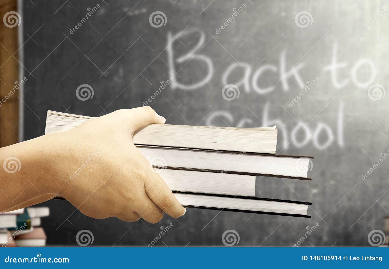 Student Hands Carrying the Pile of Books in the Classroom with Blackboard  Background Stock Photo - Image of indoors, knowledge: 148105914