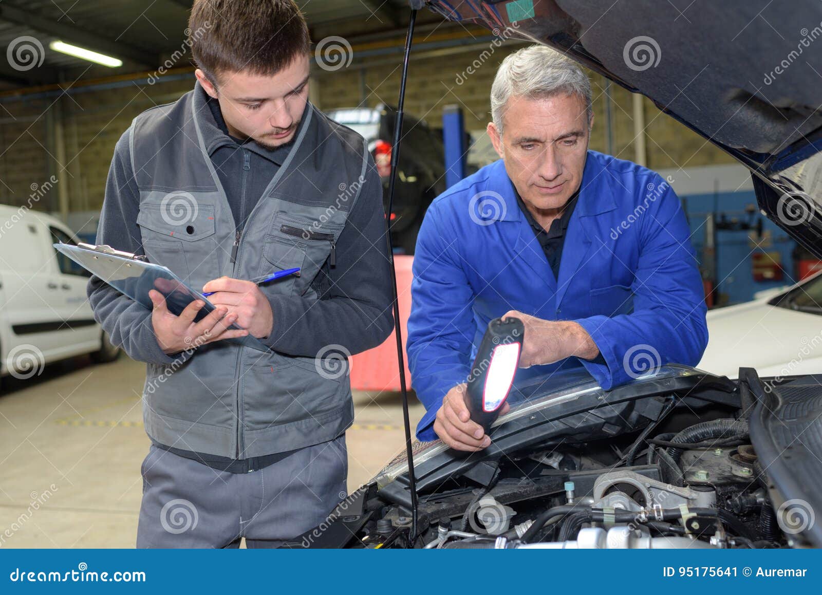 Student with Instructor Repairing Car during Apprenticeship Stock Image
