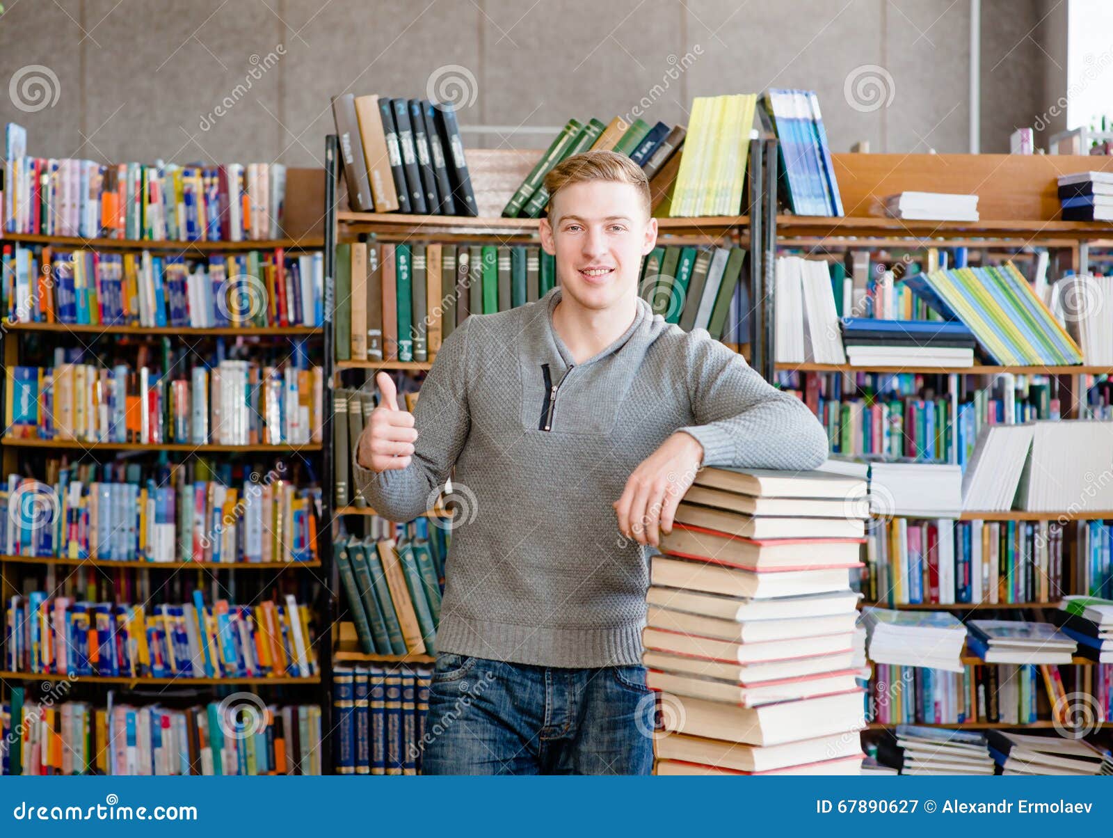 Student with Pile Books Showing Thumbs Up in College Library Stock ... photo photo