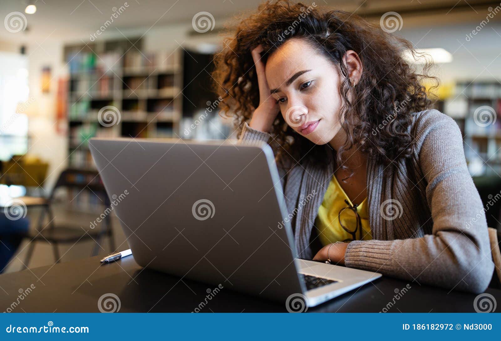 student woman finding it difficult at study and comprehend scool tasks