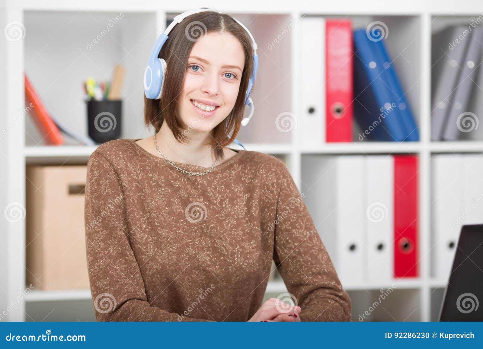 Student Woman Uses a Headset with a Microphone for Online Learning