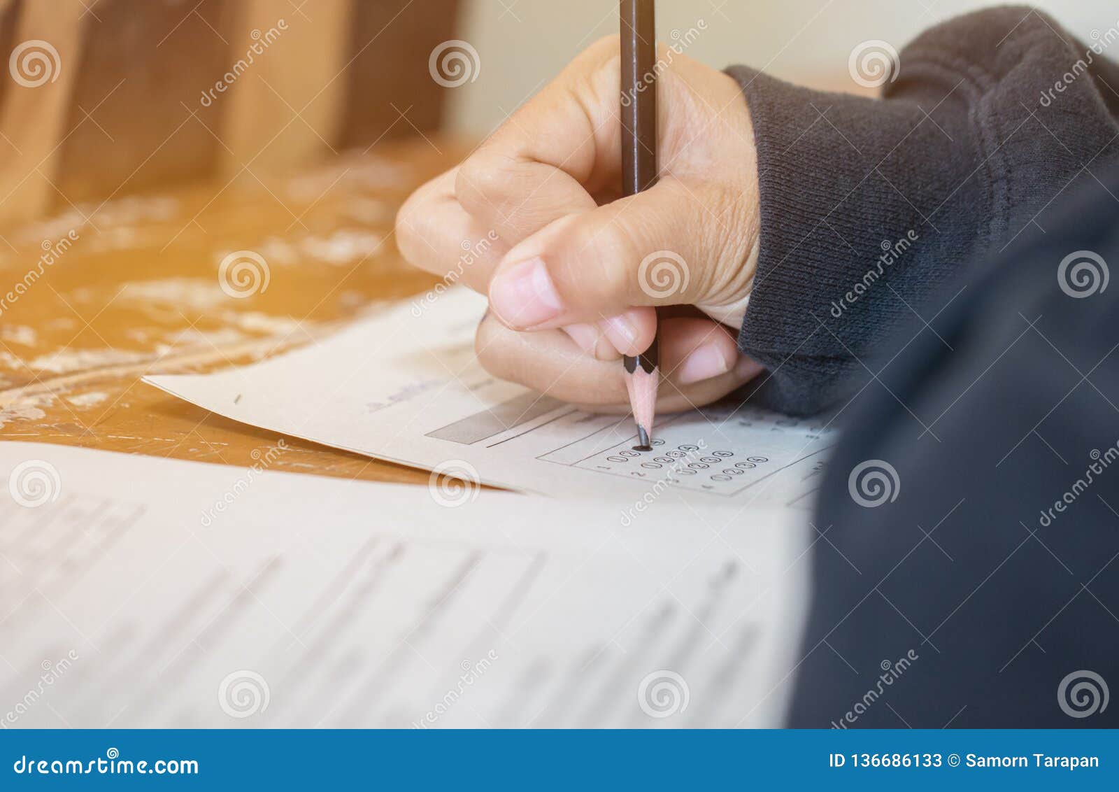 Students Concentration Holding Pencils in Hand Doing Multiplechoice