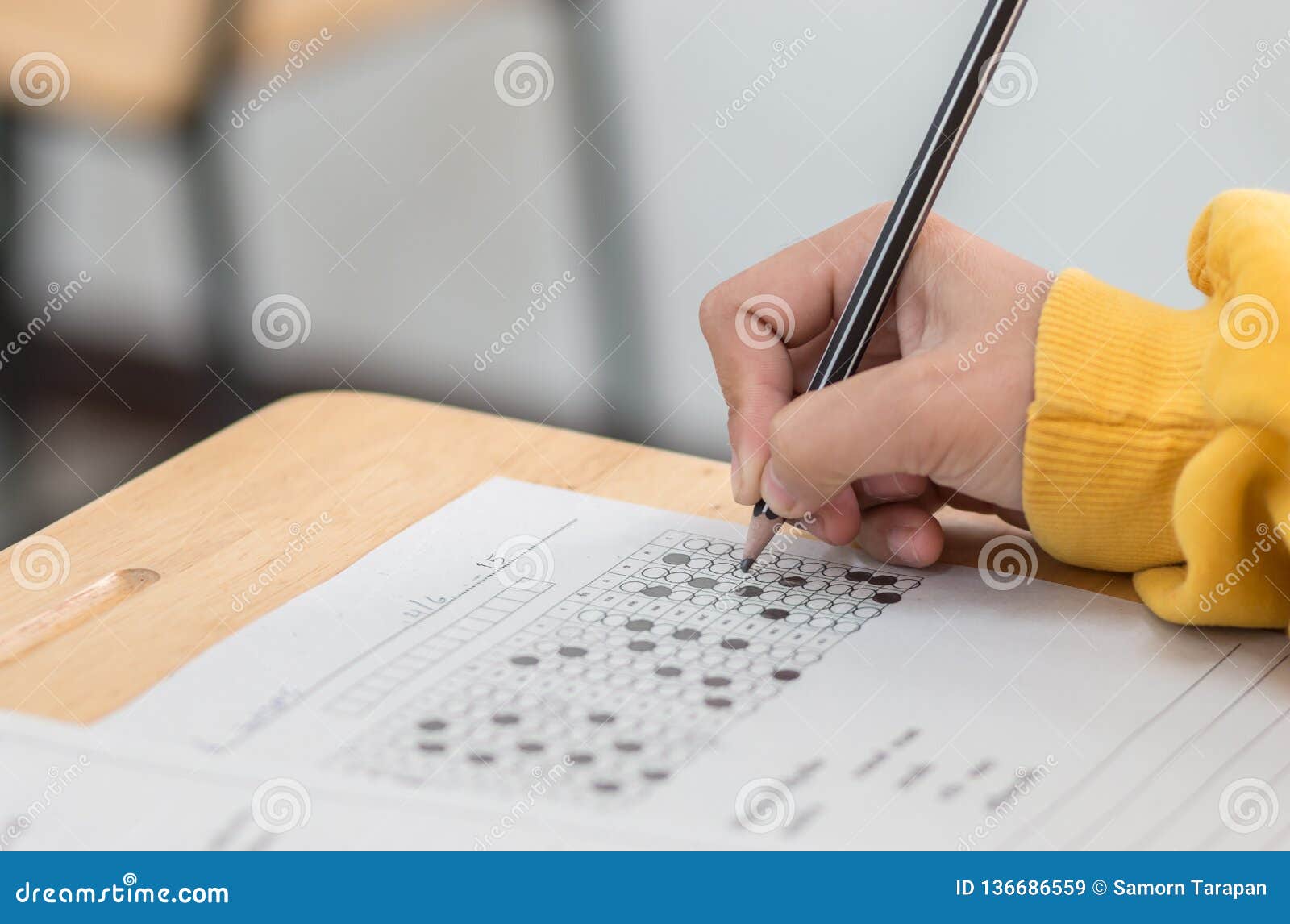 Students Concentration Holding Pencils in Hand Doing Multiplechoice