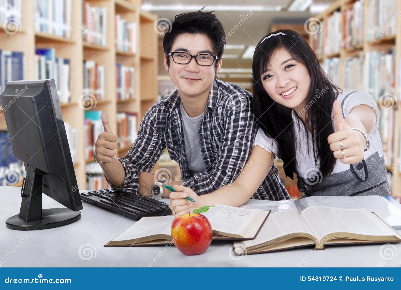 Students Showing Thumbs Up in Library Stock Photo image