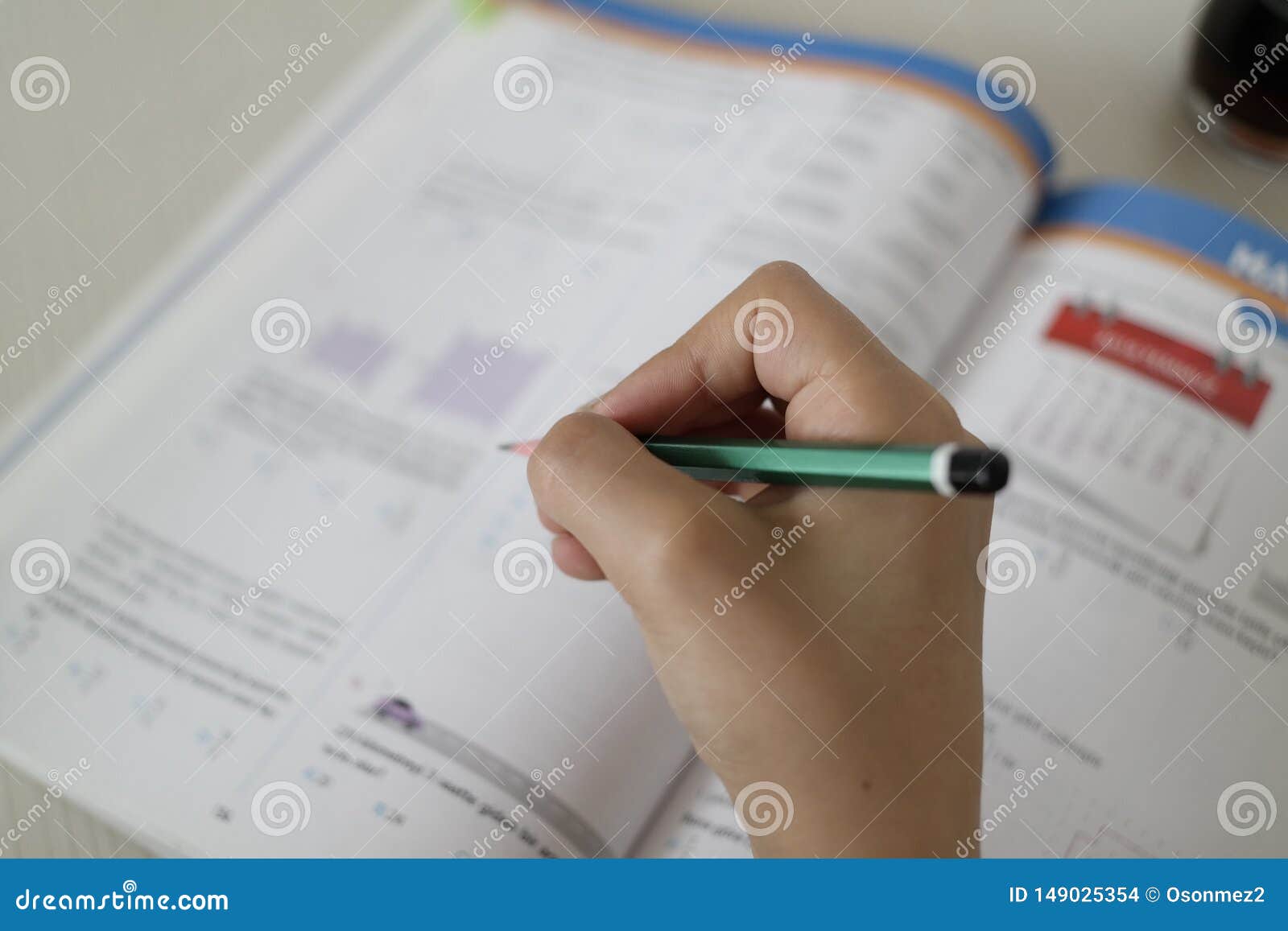 Students Solve with Pencil Tests on the Test Booklet Stock Photo