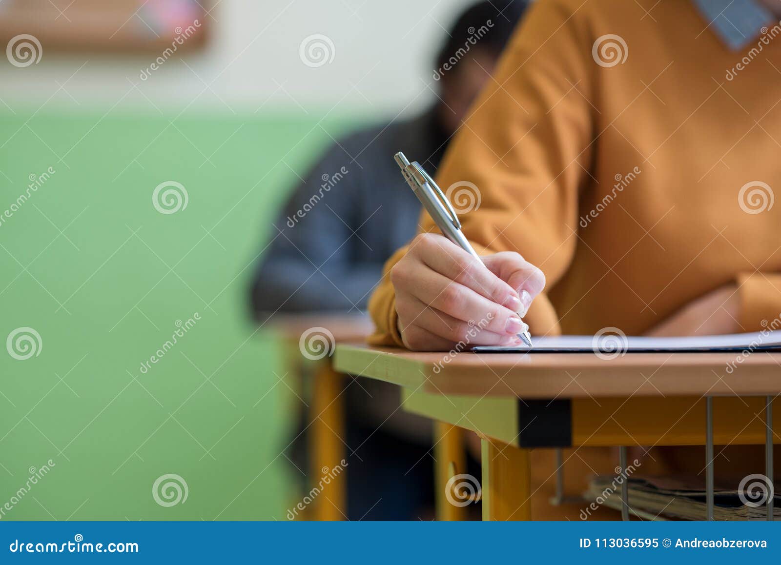 students taking exam in classroom. education test.