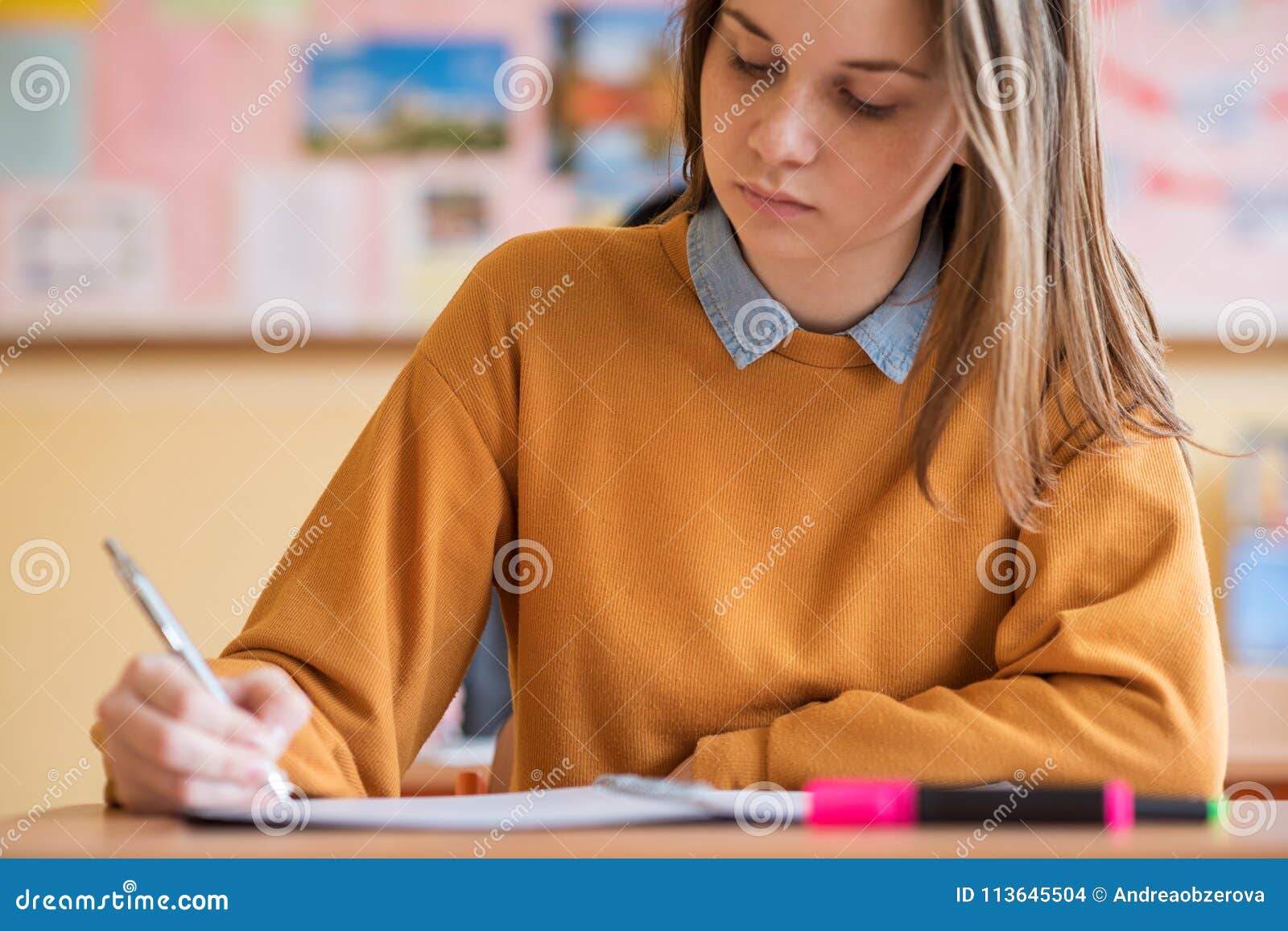 students taking exam in classroom. education test.