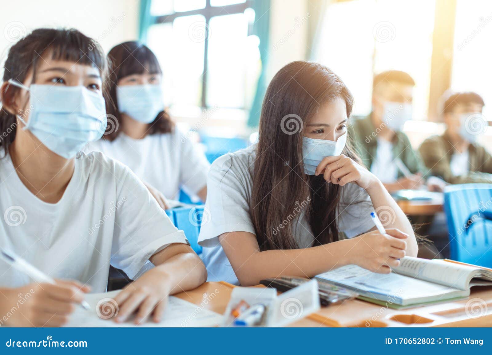 students wearing  protection mask to prevent germ, virus and pm 2.5 micron in classroom
