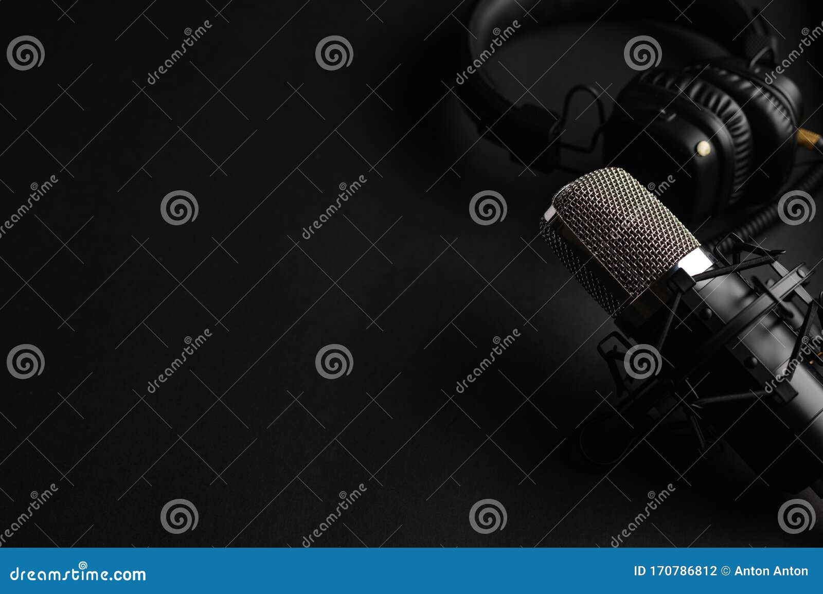 studio black studio microphone with studio headphones on a black background. banner. radio, work with sound, podcasts