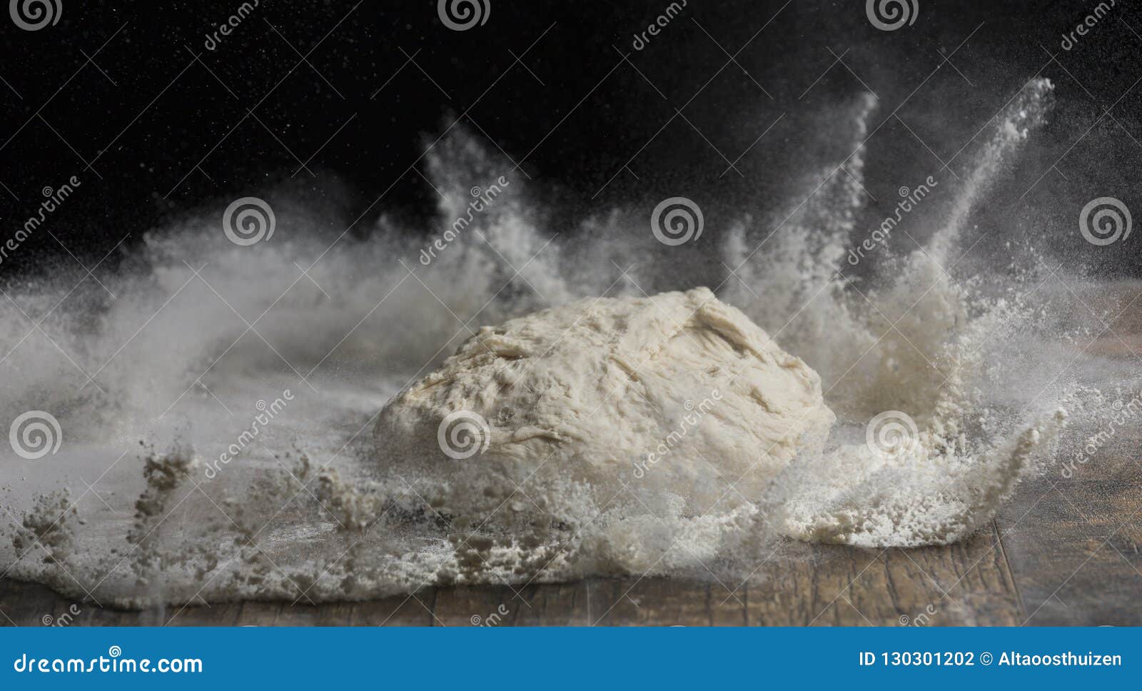 Studio Closeup Photo of a Ball of Dough Falling on Flour Stock Photo