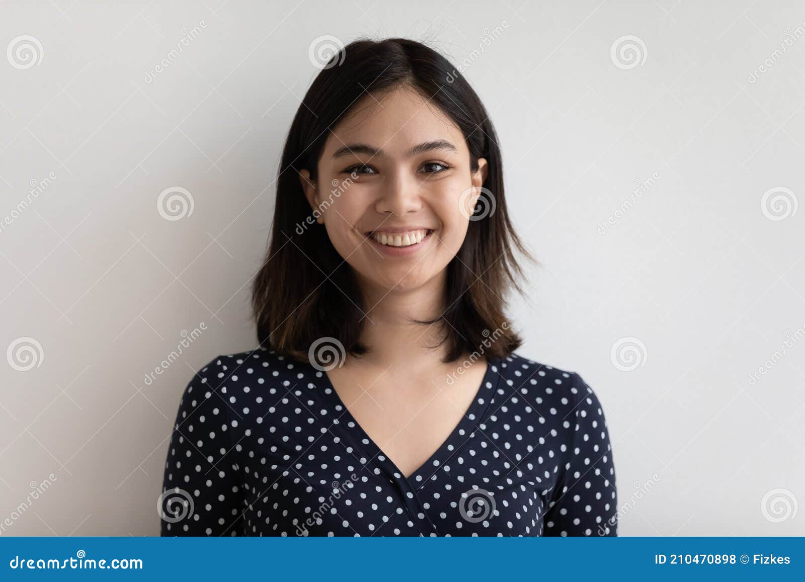 studio headshot portrait of positive young female of asian ethnicity